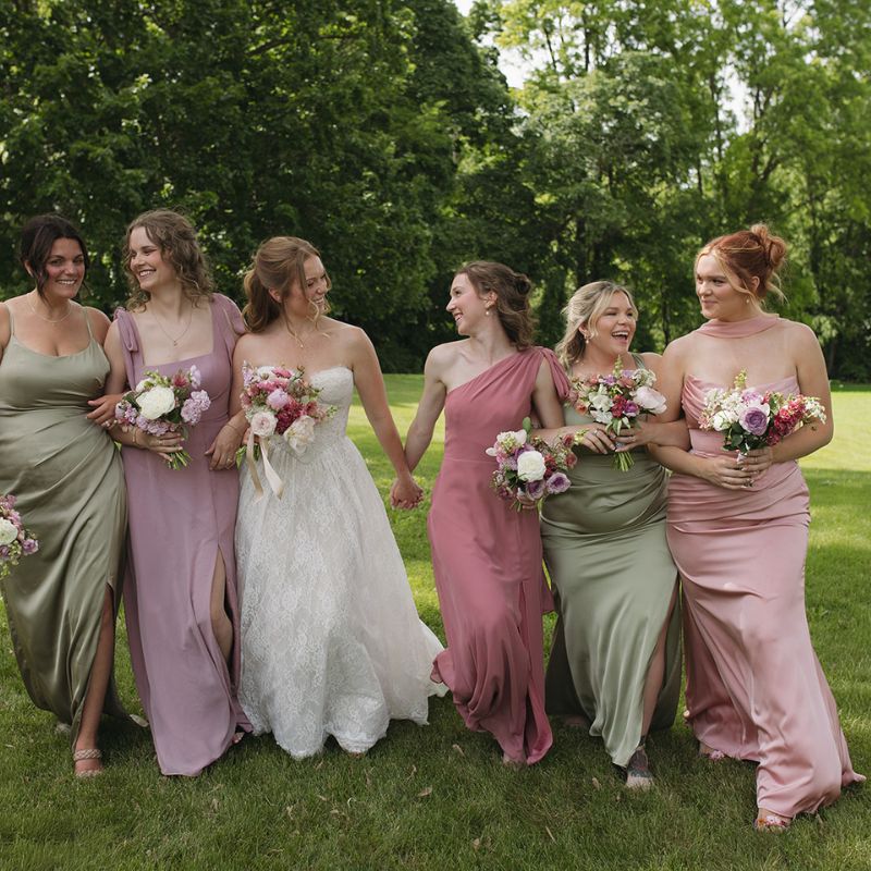 June bride with all her bridesmaids holding their flower bouquets